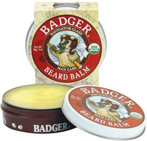 Drie blikken baardbalsem. Eén geopend, de andere gesloten. Opschrift: BADGER, BEARD BALM, USDA ORGANIC.