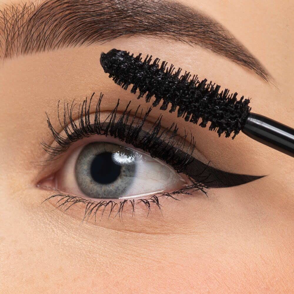 Œil avec applicateur de mascara. Mascara noir sur les cils. Trait d'eye-liner.