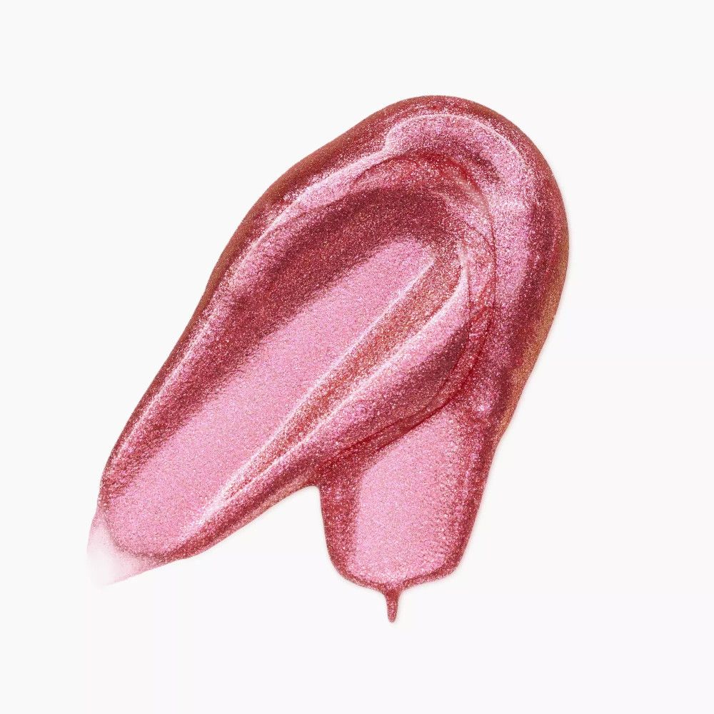 Échantillon de fard à paupières liquide rose. L'échantillon a une texture brillante et une formation de goutte.