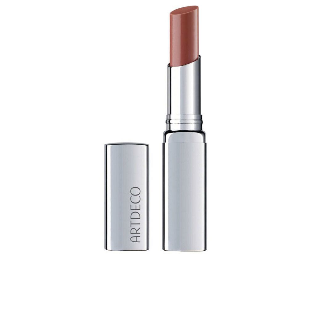 Lipbalsem met zilveren huls en open dop. De lipstick heeft een warme roze tint. "ARTDECO" staat op de huls.