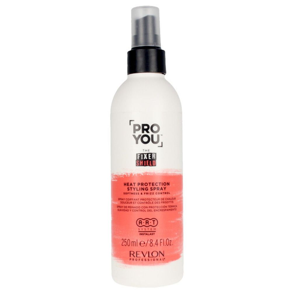 Flacon spray blanc et rouge. Inscription: PRO YOU THE FIXER SHIELD, Heat Protection Styling Spray, Revlon Professional. Tête de pulvérisation noire.