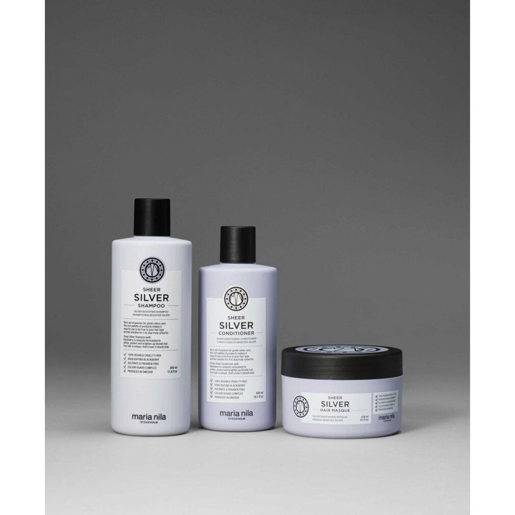 Trois produits Maria Nila : shampooing, après-shampooing et masque capillaire. Tous avec bouchon noir et inscription argentée.