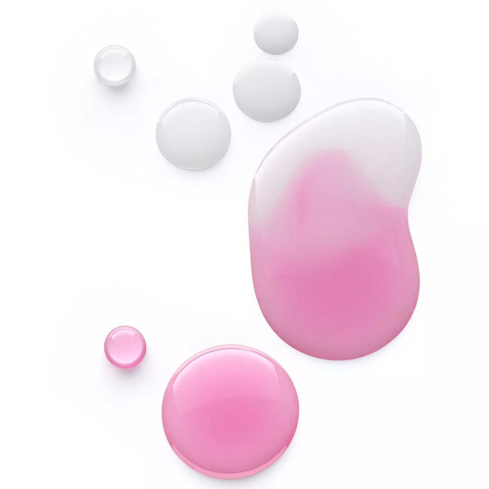 Roze lipolie-druppels op witte achtergrond. Verschillende maten en vormen. Sommige druppels zijn transparant.