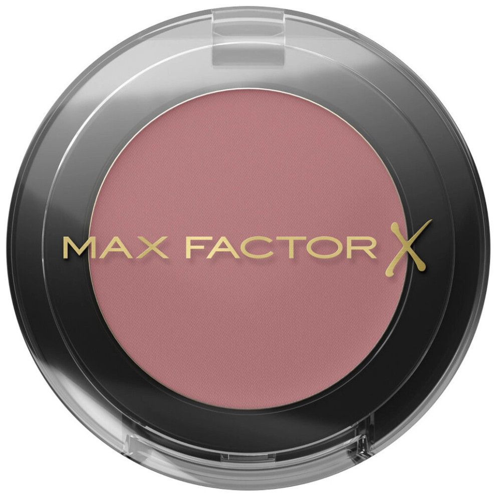 Ronde zwarte oogschaduwcontainer met transparant deksel. De oogschaduw is roze. Het deksel draagt de merknaam.