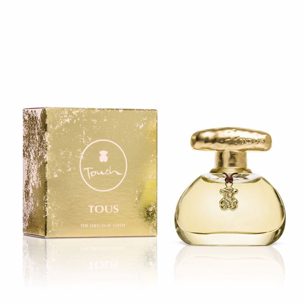Parfumfles en doos. Fles met gouden dop en hanger. Doos met logo en tekst Tous Touch.