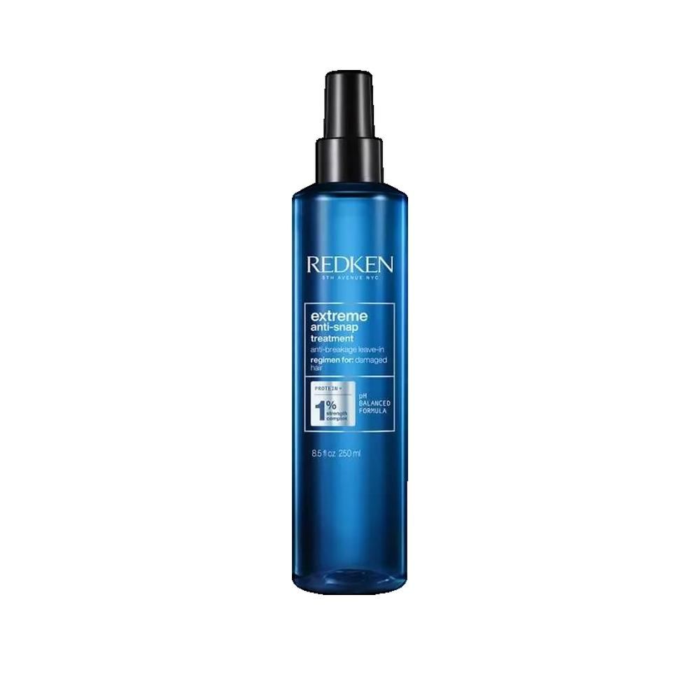 Flacon bleu avec vaporisateur noir. Inscription: Redken, Extreme Anti-Snap Treatment. Pour cheveux abîmés. Avec 1% Balanced Formula.