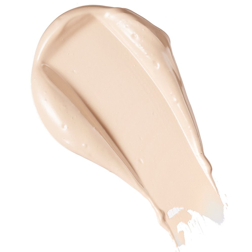 Nuance de correcteur clair, texture crémeuse, sur fond blanc. Échantillon de produit.