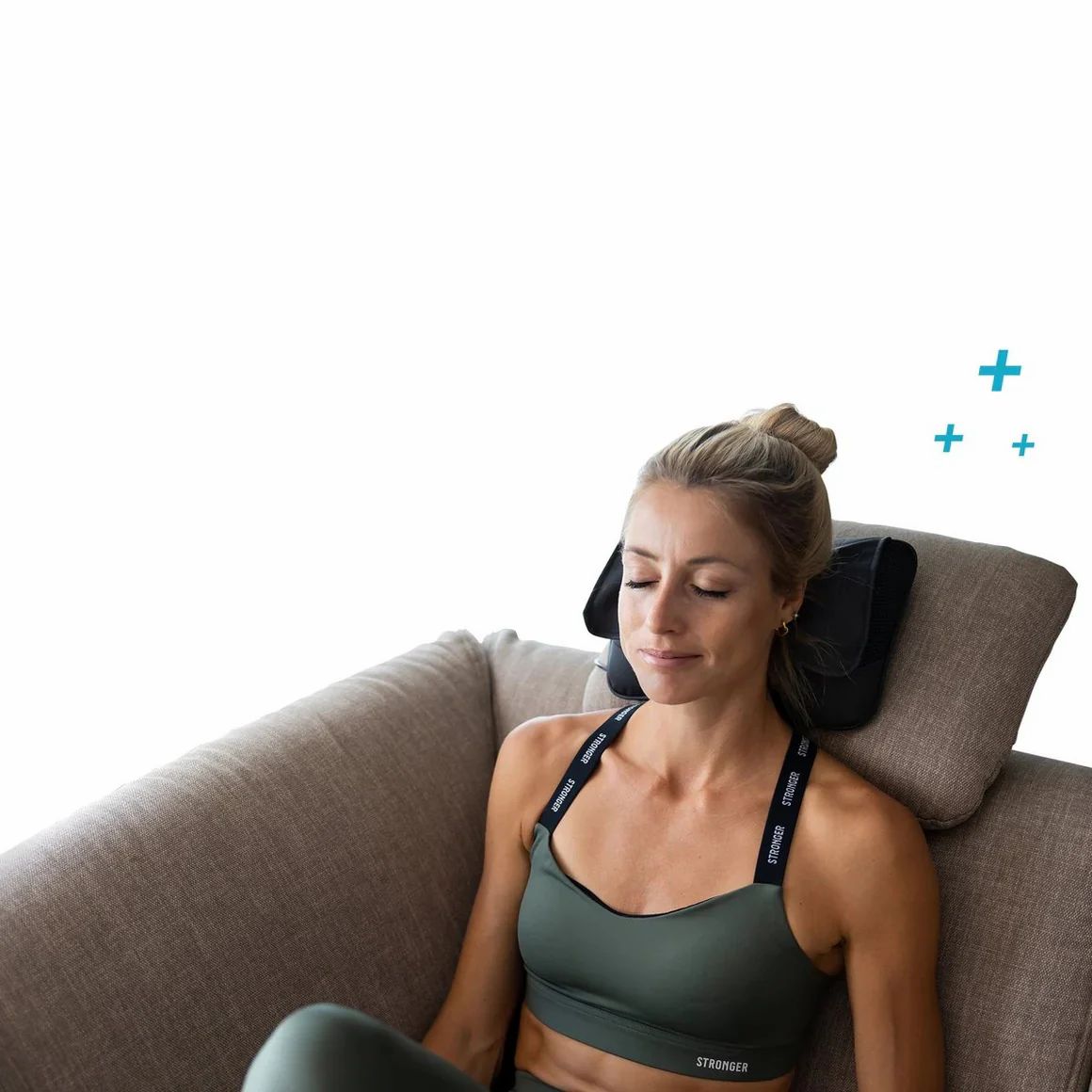 Vrouw op een bank met nekmassageapparaat. Zwart apparaat op de nek. Vrouw met gesloten ogen.