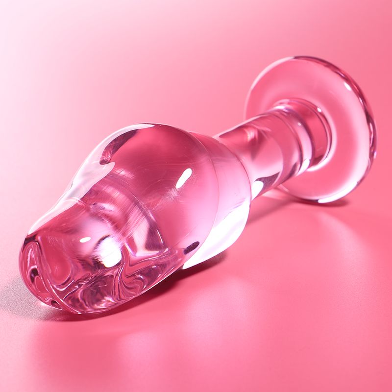 Plug en verre rose avec une base large et une forme ergonomique.