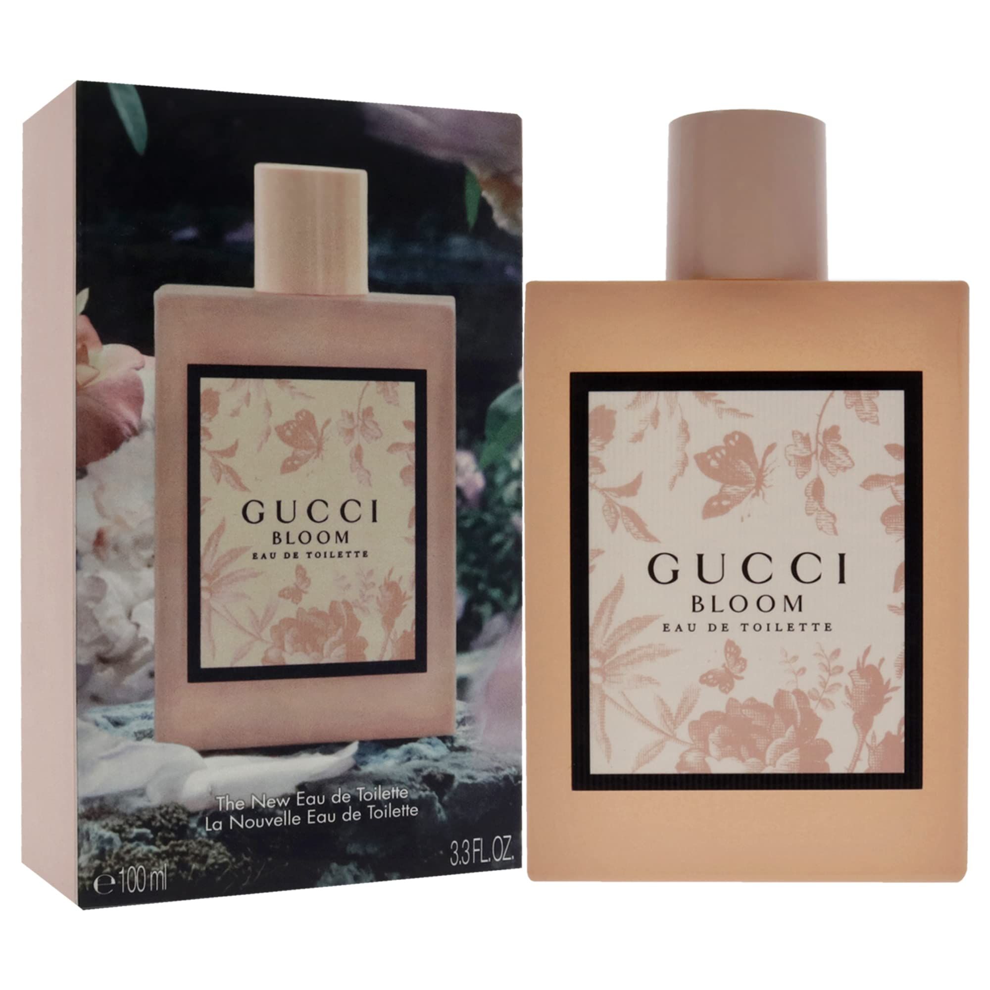 Roze fles en doos. Opschrift Gucci Bloom. Zwarte kader met bloemmotief. Eau de Toilette.