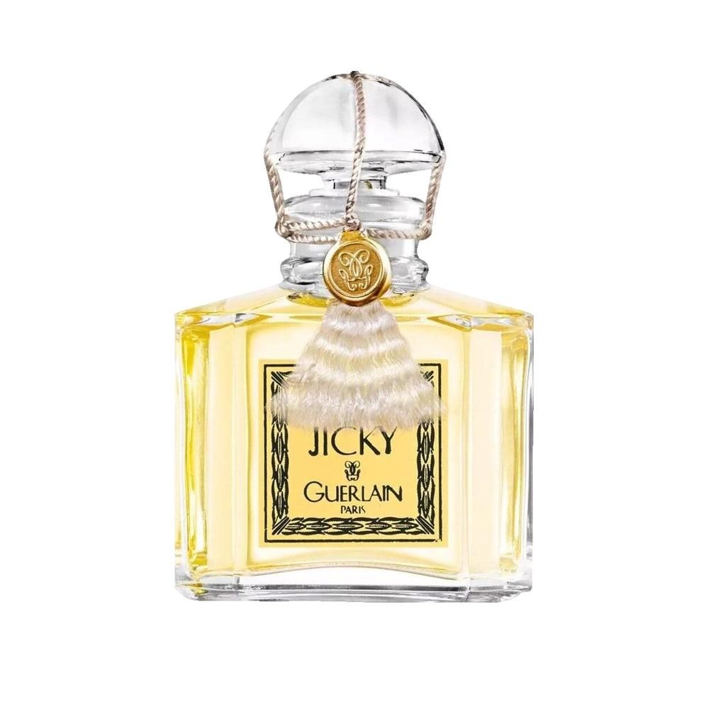 Flacon de parfum avec pompon et bouchon. Inscription Jicky et Guerlain Paris. Forme carrée, liquide jaune.