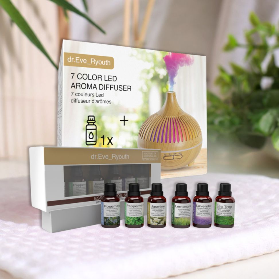 Dr. Eve Ryouth Diffuseur d'arômes LED 7 couleurs et 6 huiles essentielles. Diffuseur aspect bois, vapeur colorée, 6 flacons d'huile sur tissu blanc.