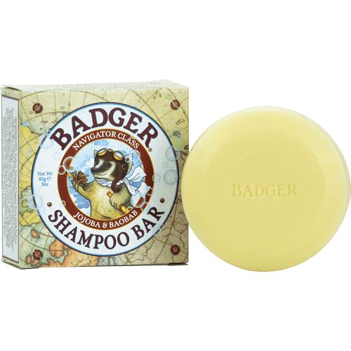 Gele shampoo bar en doos. Doos met logo en tekst: Badger Shampoo Bar. Bar met tekst: Badger.