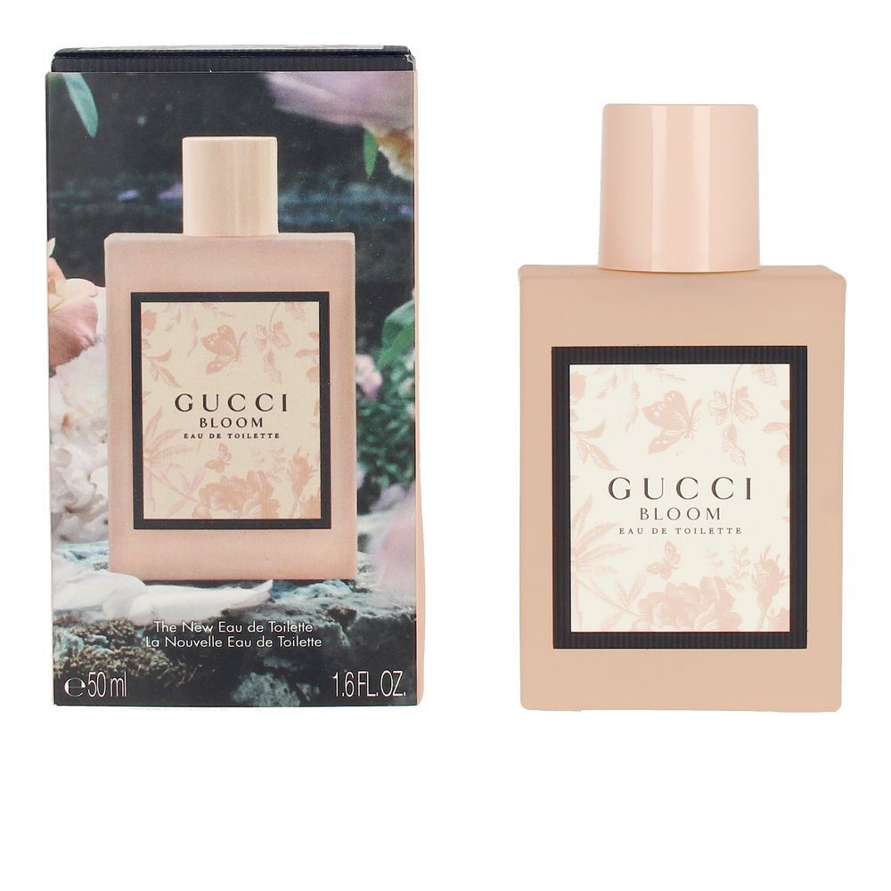 Roze fles met opdruk, naast verpakking met bloemmotief. Opschrift: Gucci Bloom Eau de Toilette.