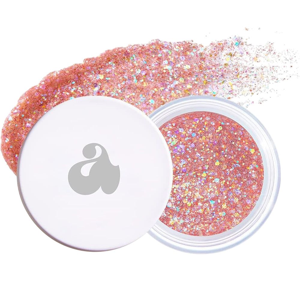 Pot de paillettes avec paillettes roses. Couvercle blanc avec logo. Nom du produit non visible.