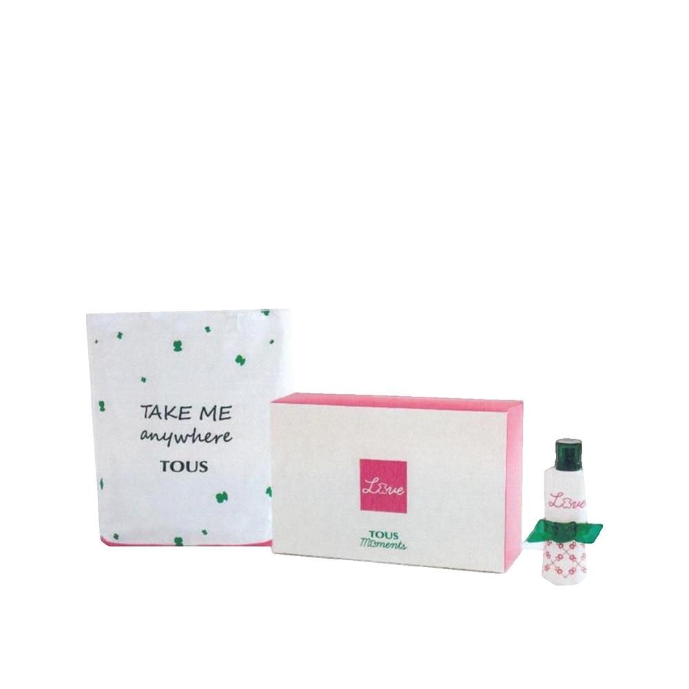 Coffret cadeau parfum avec flacon, emballage et sac. Flacon avec bouchon et nœud vert. Emballage avec accents roses et inscription "Love".