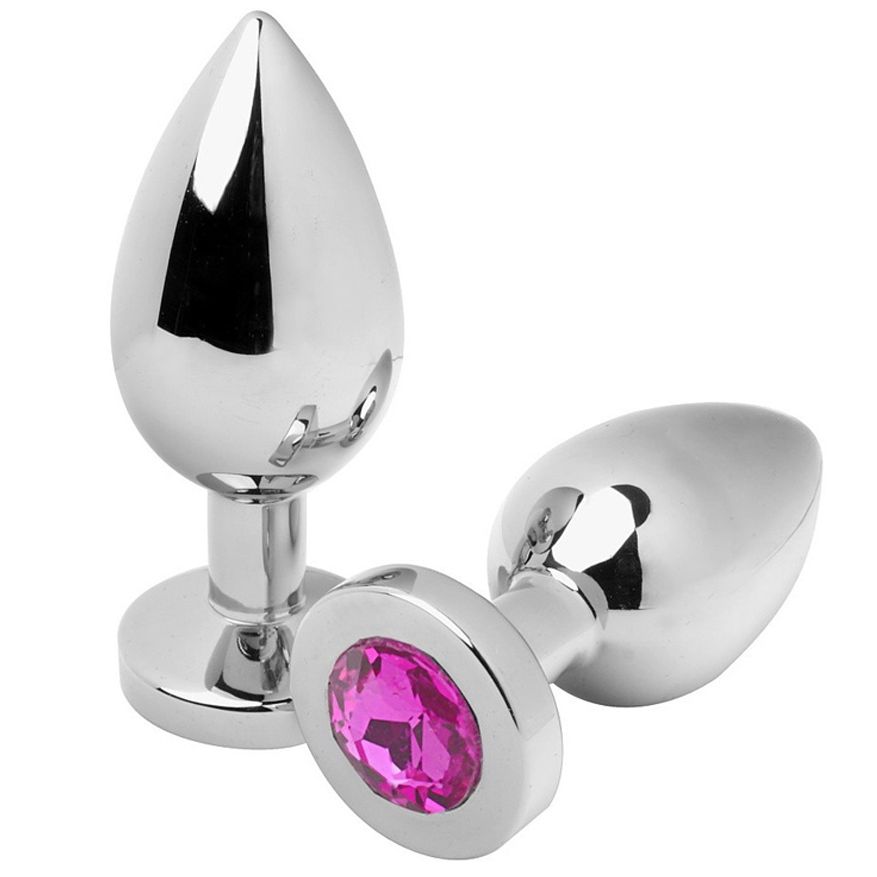 Deux plugs anaux métalliques. Un avec pierre rose. Pointe en forme de goutte, base ronde.