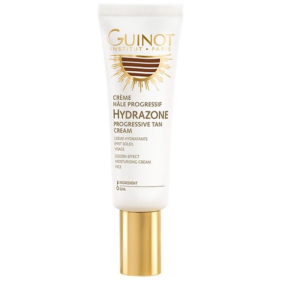 Witte tube met gouden dop. Opschrift: Guinot, Crème Hâle Progressif Hydrazone, Progressive Tan Cream. Zonne-motief.