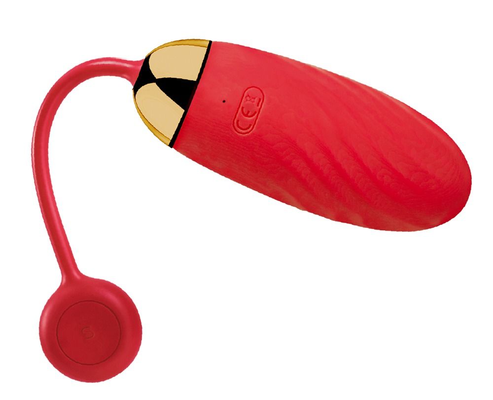 Vibrateur rouge avec extrémité dorée et base ronde rouge. Marquage CE visible.