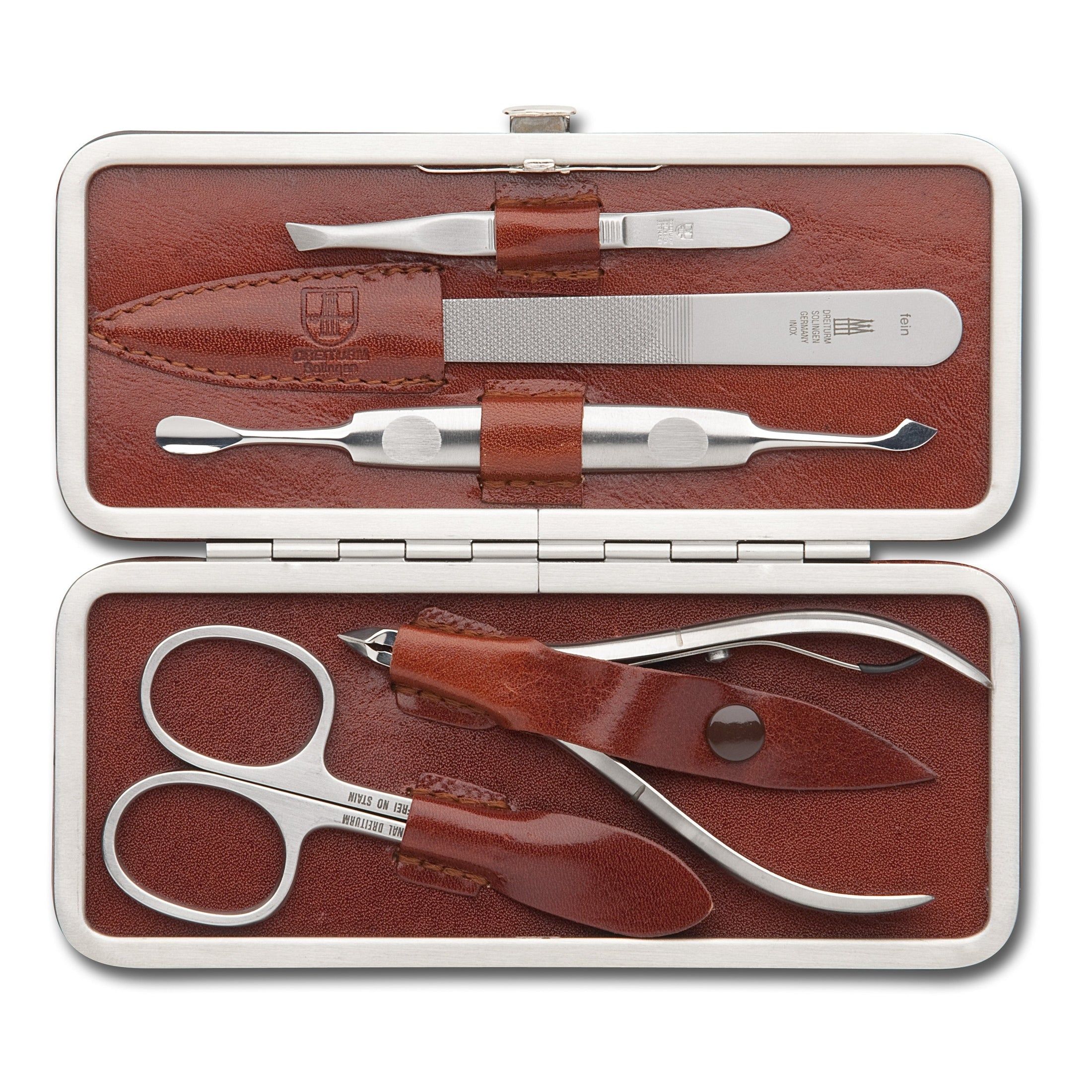 Open bruin lederen etui met manicuregereedschap. Schaar, nagelvijl, pincet, nagelknipper en gereedschap.