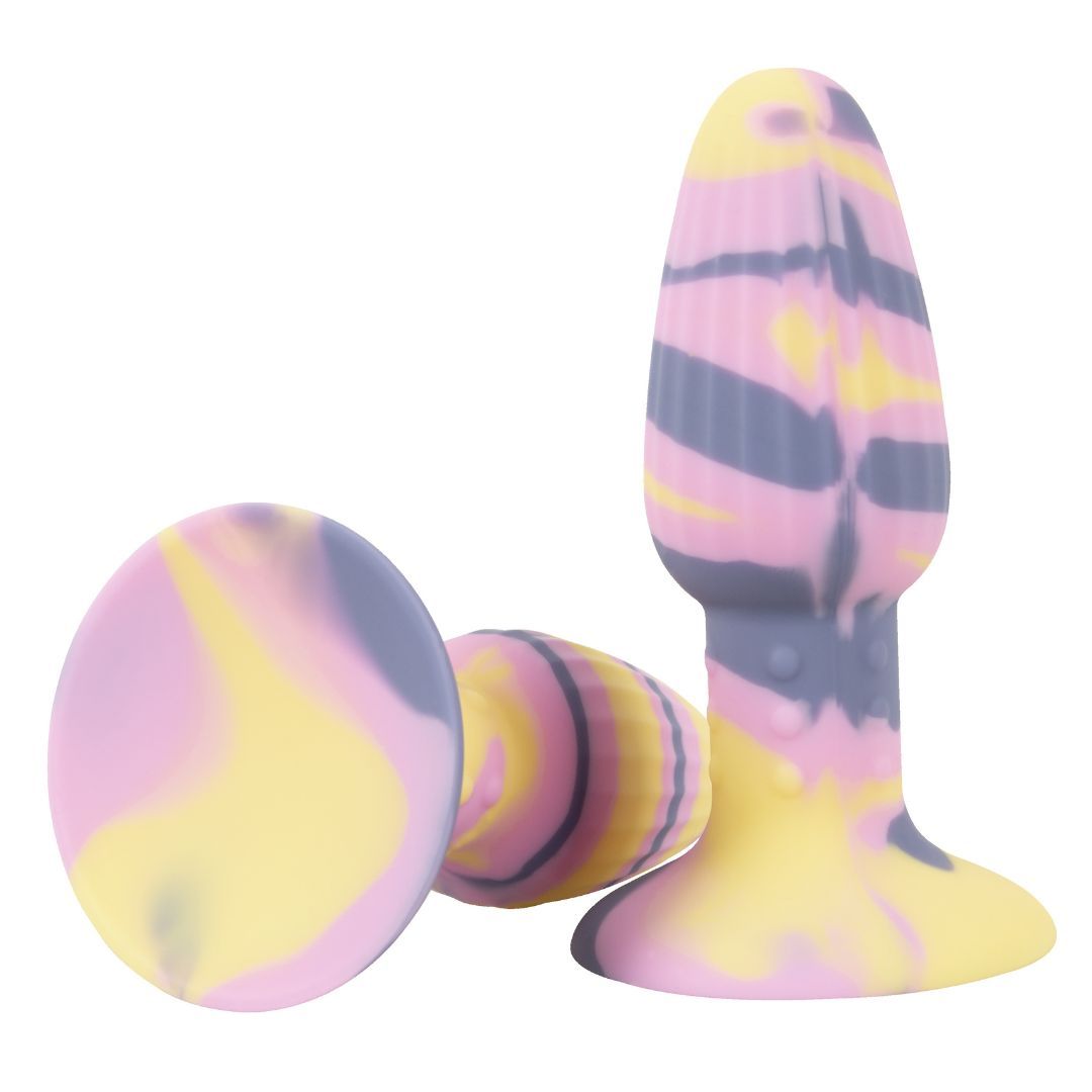 Plug anal avec ventouse. Design multicolore jaune, rose et violet. Deux autres éléments ronds.