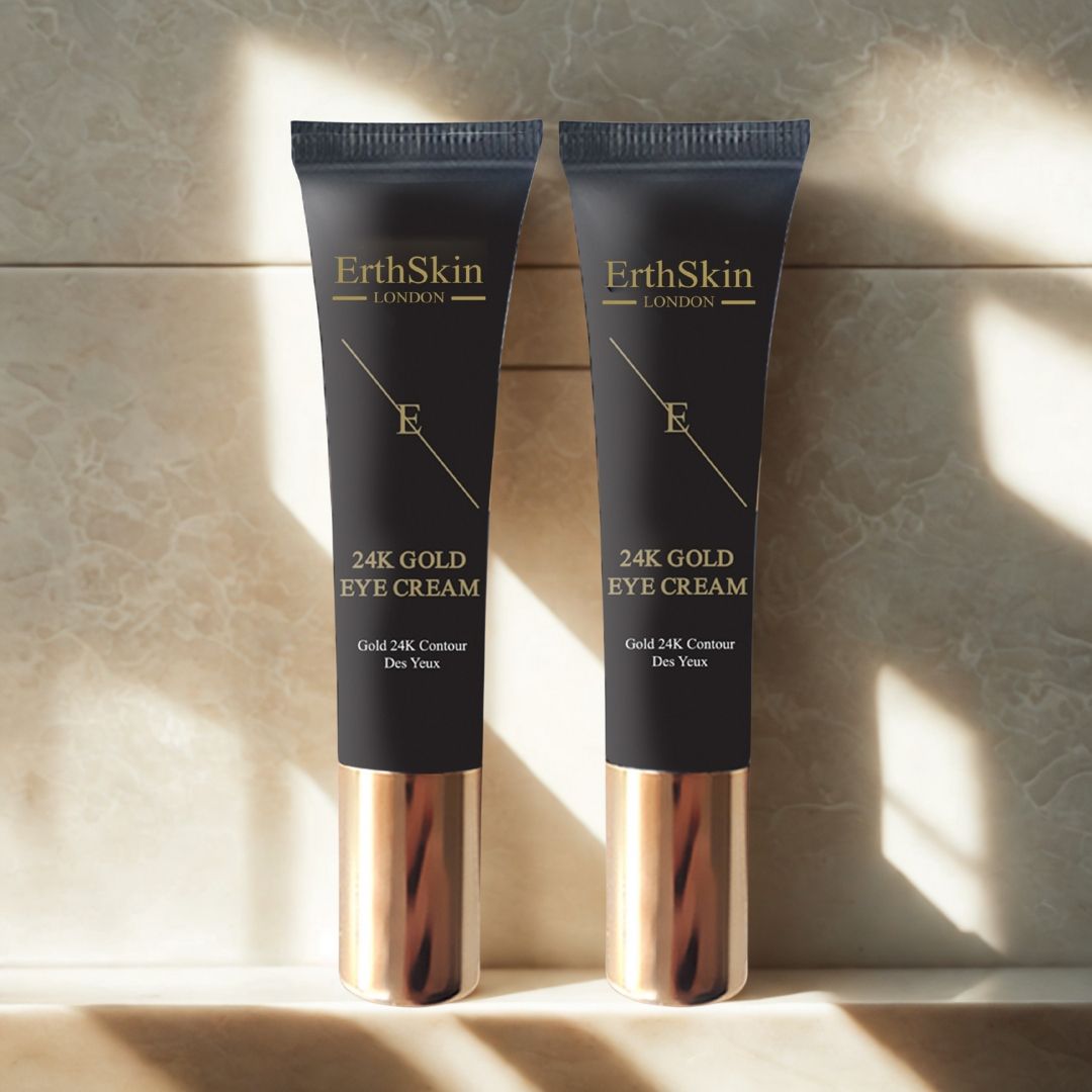 Deux tubes de crème pour les yeux. Tubes noirs avec détails dorés. Inscription: ErthSkin London, 24K Gold Eye Cream. Placé sur des carreaux.