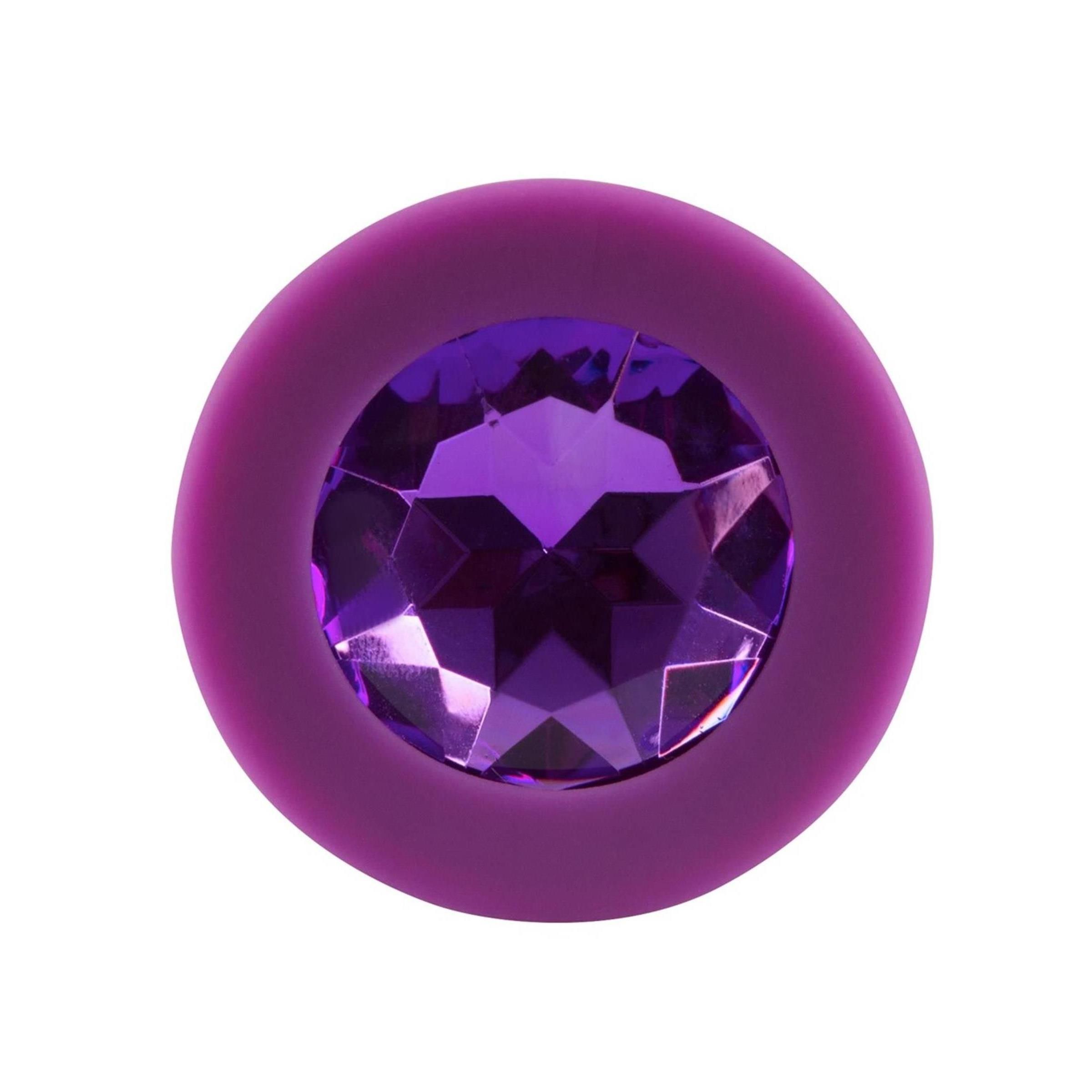 Plug anal violet avec bijou, gros plan sur le bijou.