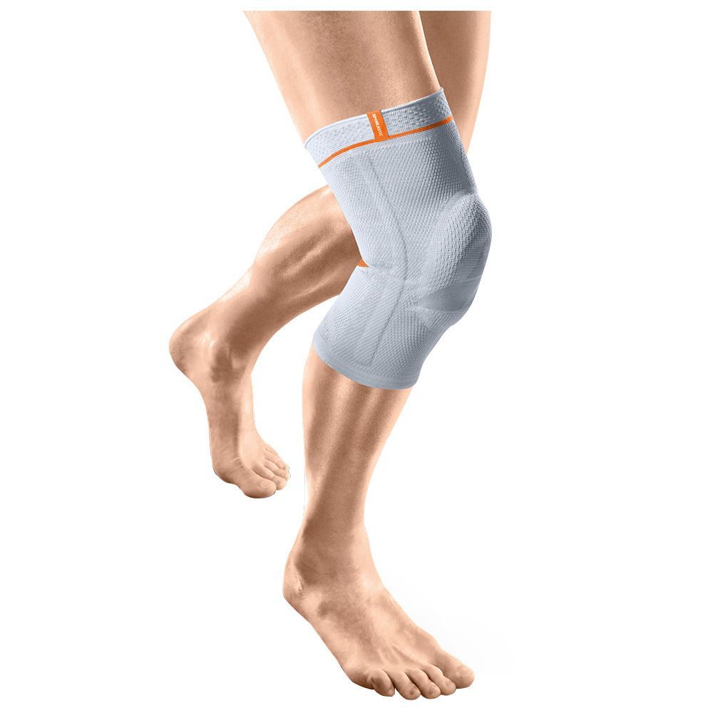 Kniebrace, lichtgrijs met oranje accenten. Gedragen op been. Toont kniegewricht. Elastisch materiaal.