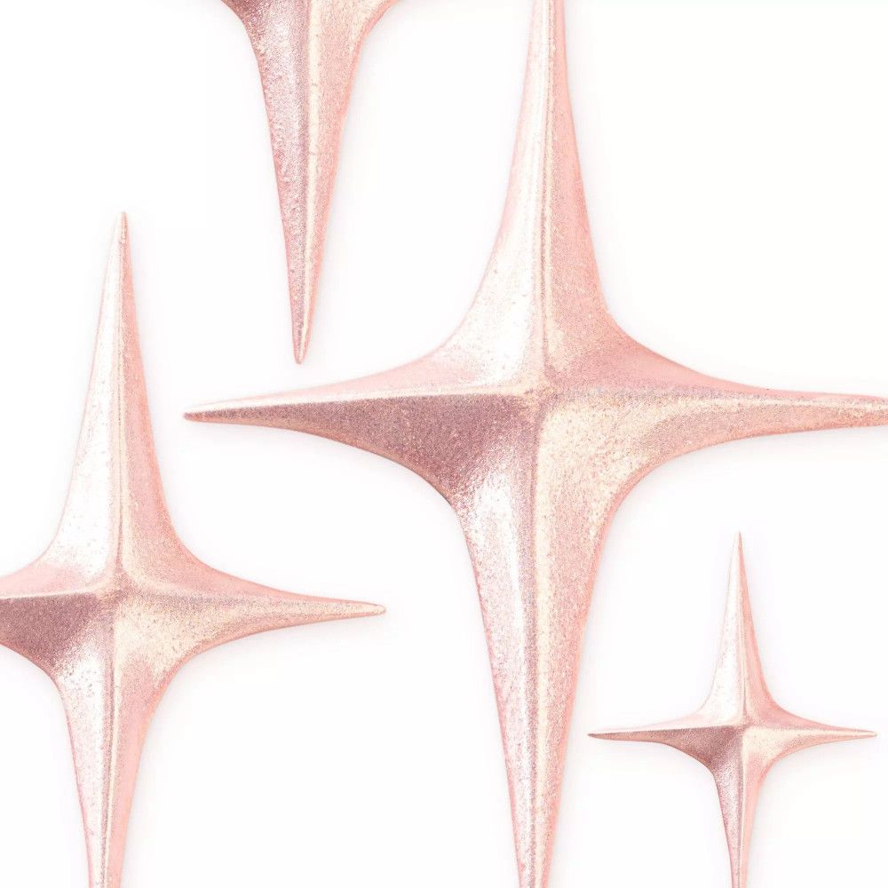 Plusieurs objets en forme d'étoile avec un scintillement rose sur fond blanc.