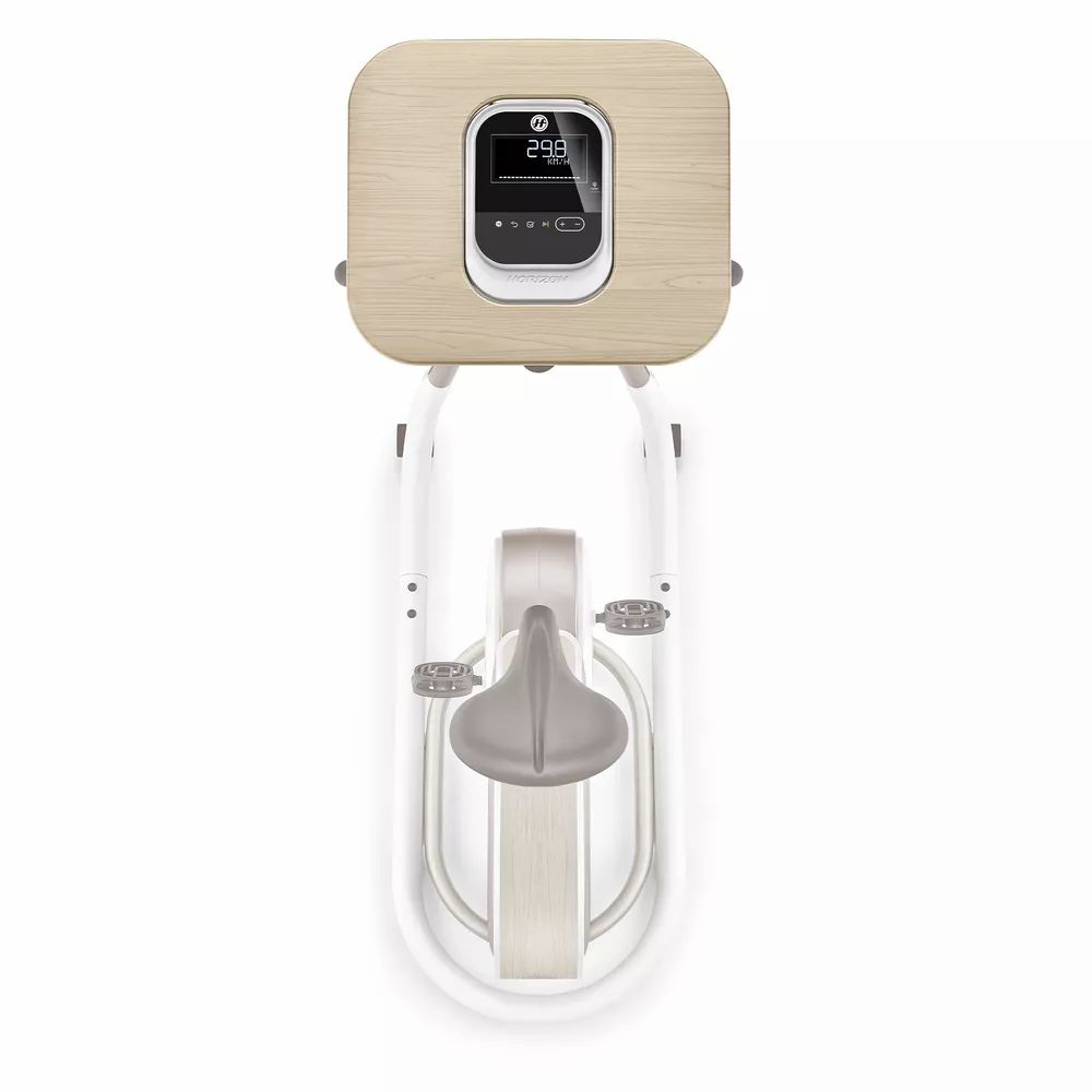 Home trainer avec console aspect bois et écran. Cadre blanc, selle grise. Vue de dessus.