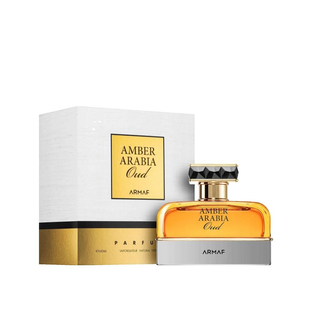 Flacon de parfum à côté d'une boîte blanche. Inscription: Amber Arabia Oud, Armaf. Détails dorés.