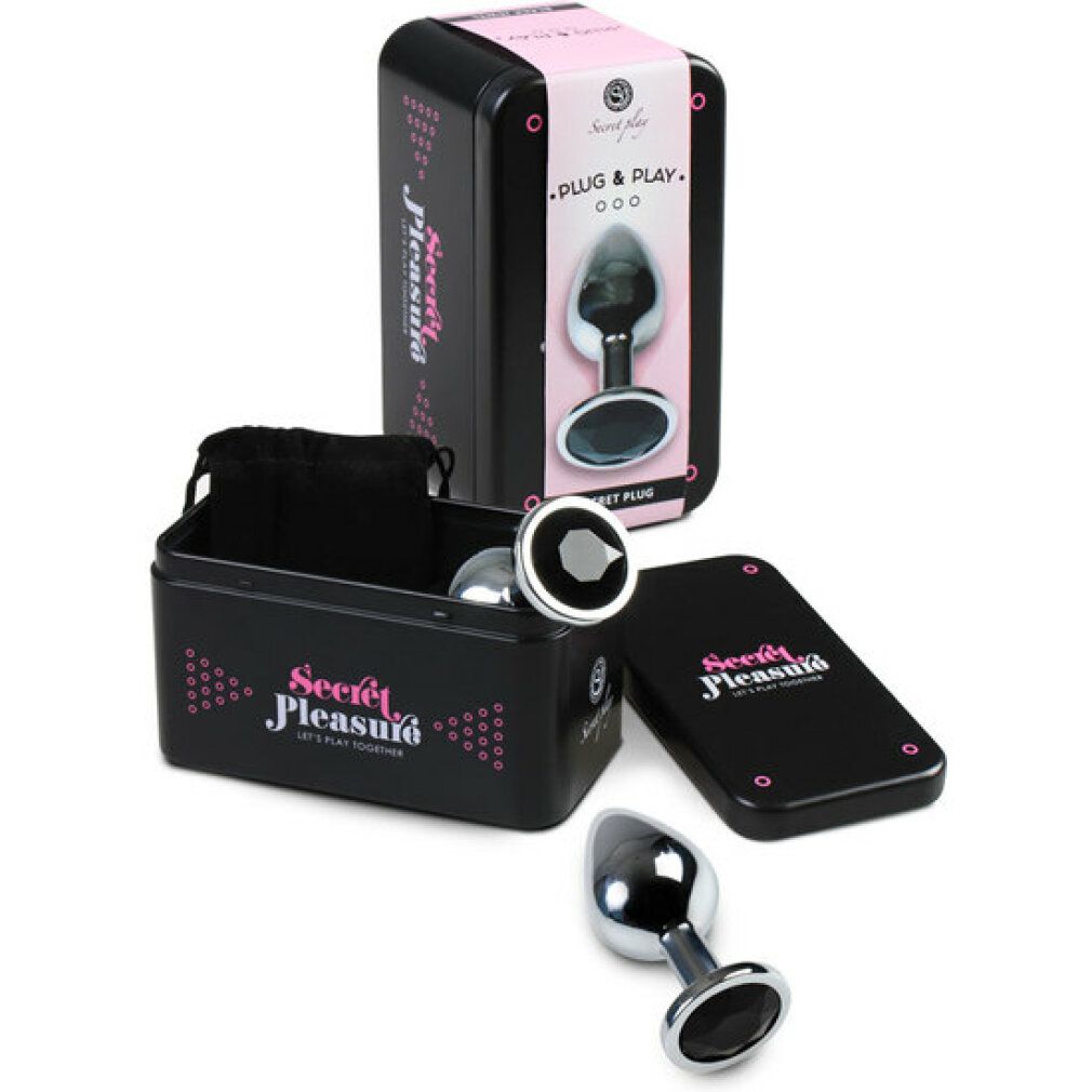 Plug anal en métal avec une large base et des ornements de pierres noires. Boîte de rangement et pochette incluses.