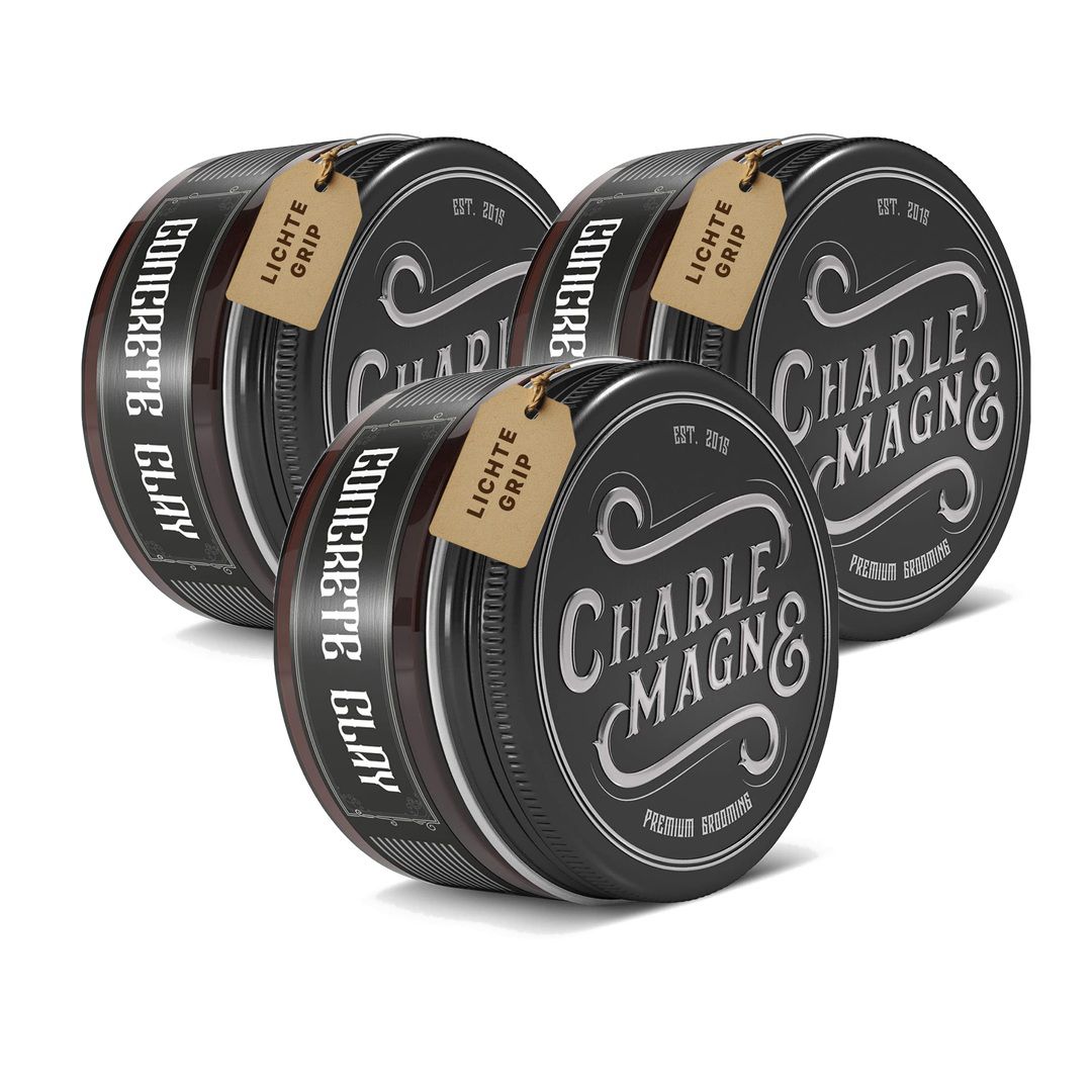 Trois boîtes rondes noires "Concrete Clay" avec couvercle argenté et étiquette marron. "Léger maintien" est imprimé sur l'étiquette.