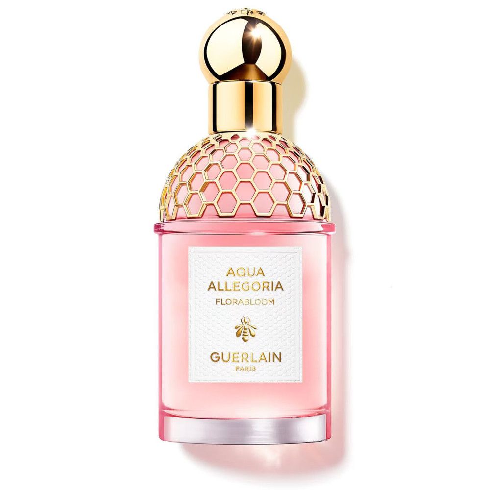 Flacon de parfum avec bouchon doré et liquide rose. Inscription: Aqua Allegoria Florabloom, GUERLAIN.