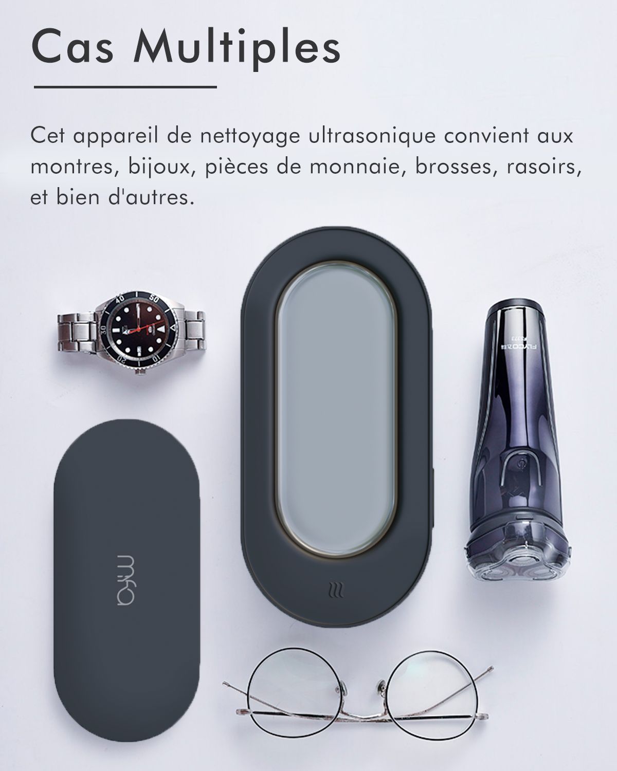 Divers objets: montre, appareil de nettoyage, rasoir, lunettes, bijoux. Appareil de nettoyage noir.