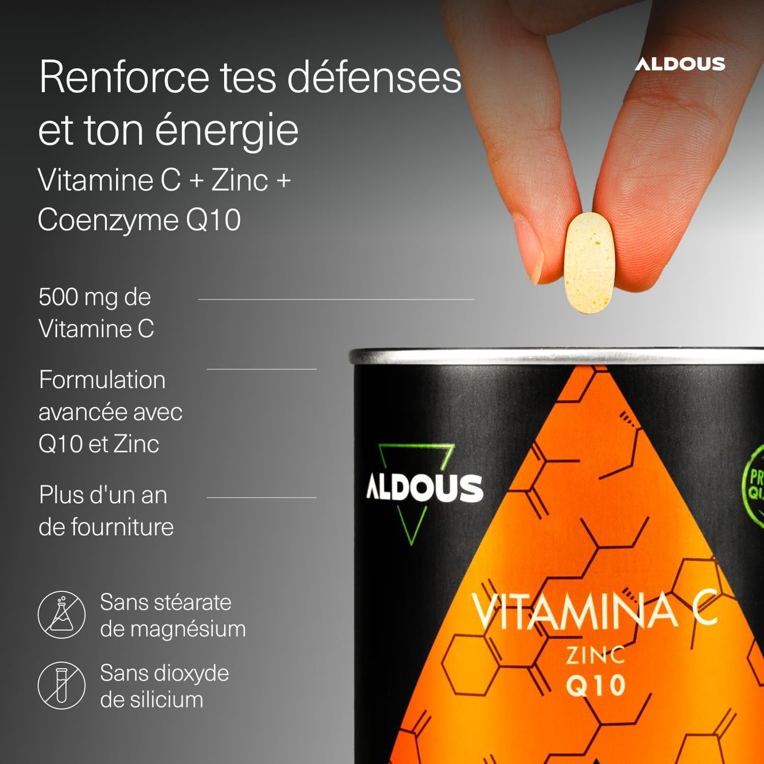 Boîte Aldous de Vitamine C, Zinc et Coenzyme Q10. Une tablette tenue par une main.