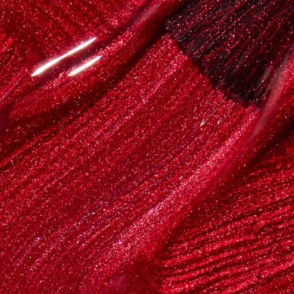 Rode nagellak, glanzend, met glitter. De textuur is in streken aangebracht.