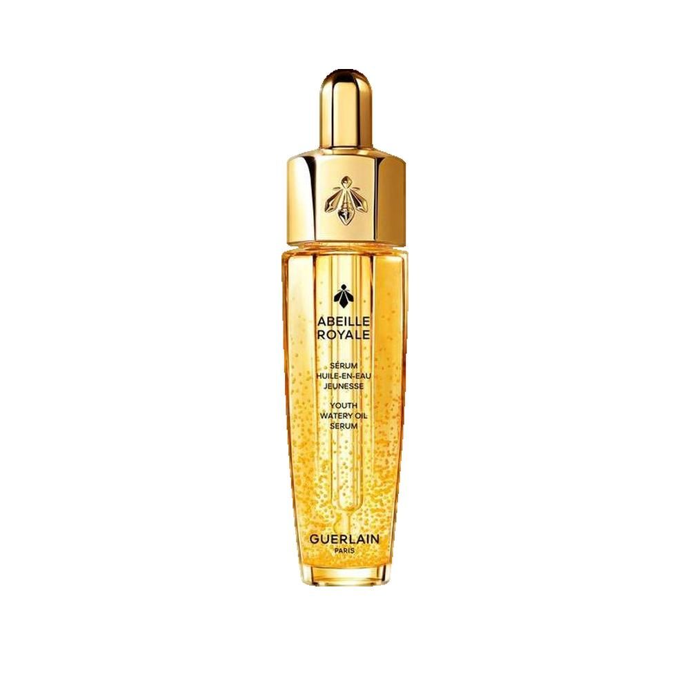 Flacon doré avec bouchon doré. Inscription: Abeille Royale, Sérum Huile en Eau Jeunesse, Guerlain Paris.
