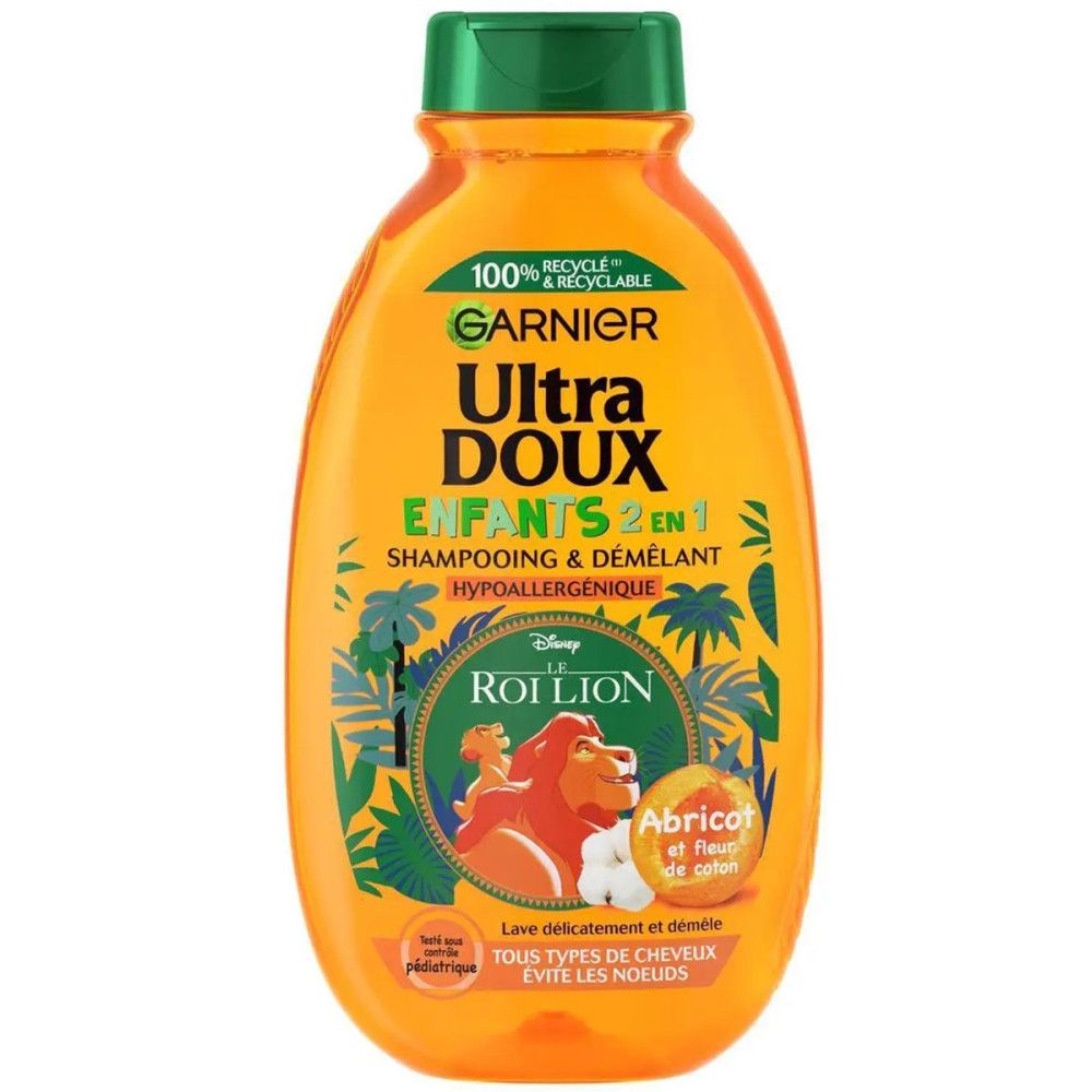 Oranje shampoo fles met groene dop. Opschrift: Garnier Ultra Doux Enfants 2 en 1, De Leeuwenkoning. Bevat abrikoos en katoenbloem.