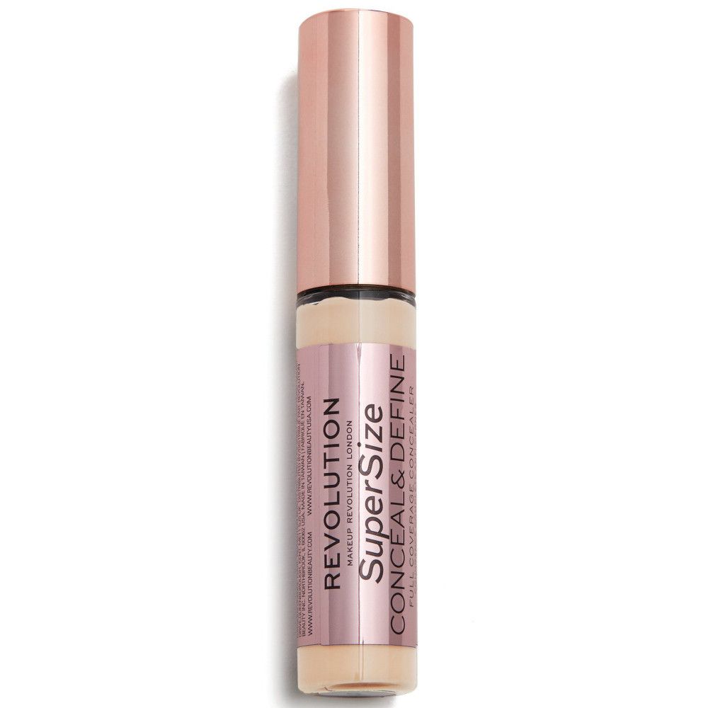 Flacon de correcteur avec bouchon or rose. Nom du produit et marque visibles.