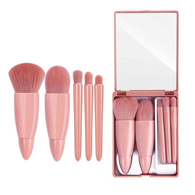 Set de pinceaux de maquillage rose avec miroir, comprenant cinq pinceaux.