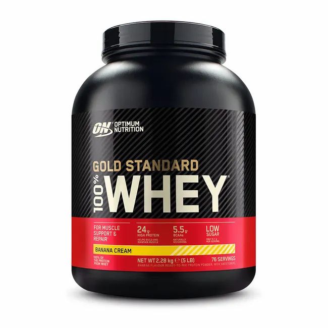 Zwarte container met "100% Gold Standard Whey" opschrift, bananencrème smaak.