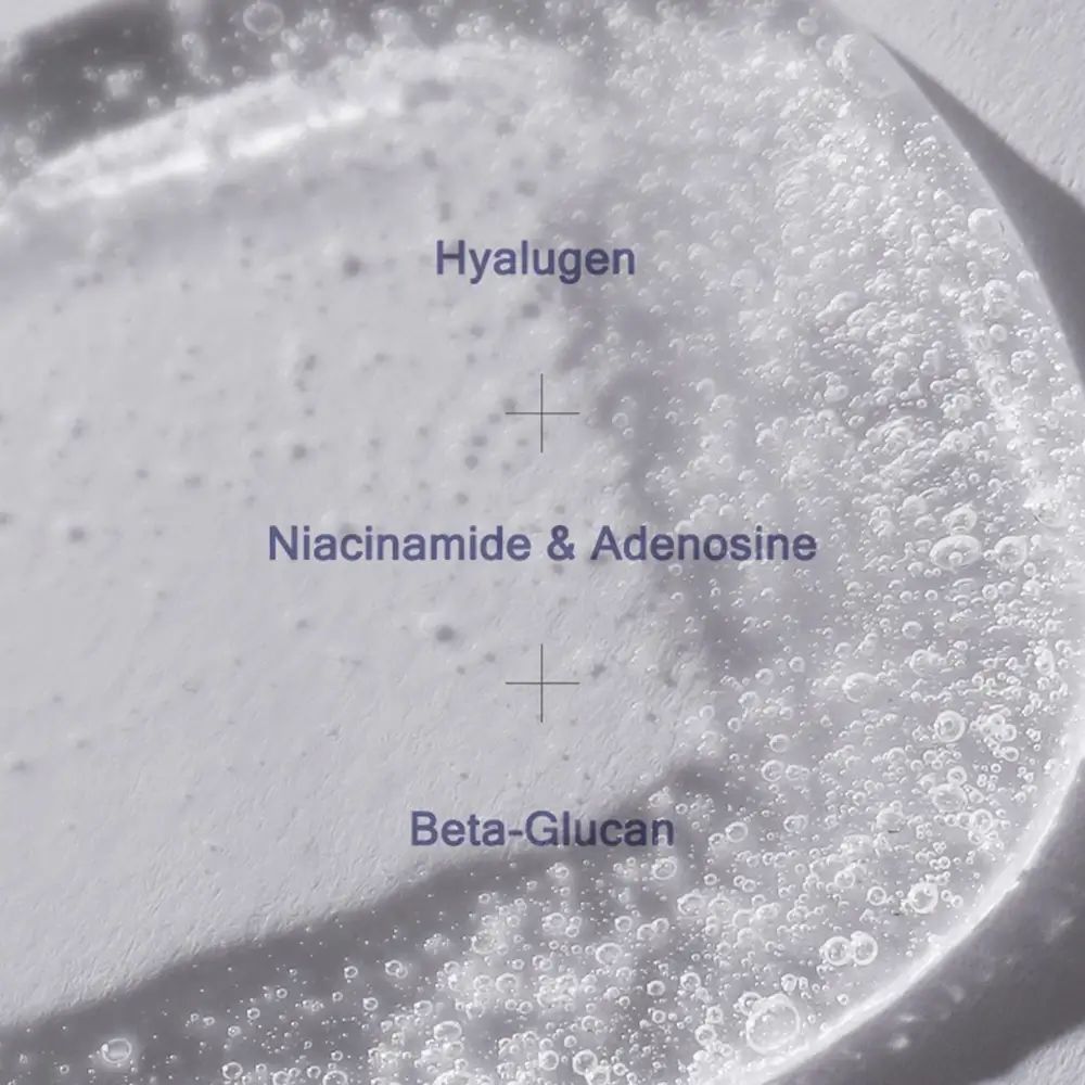 Close-up van serum met bellen. Opschrift: Hyalugen, Niacinamide & Adenosine, Beta-Glucan.