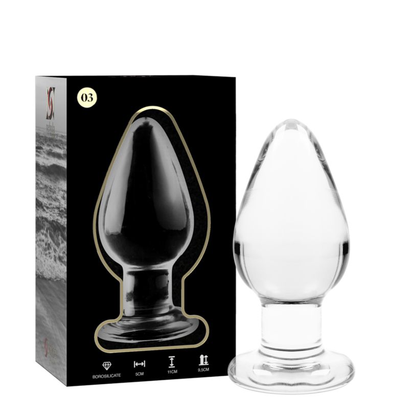 Plug anal en verre transparent avec une base large. Présenté avec son emballage.