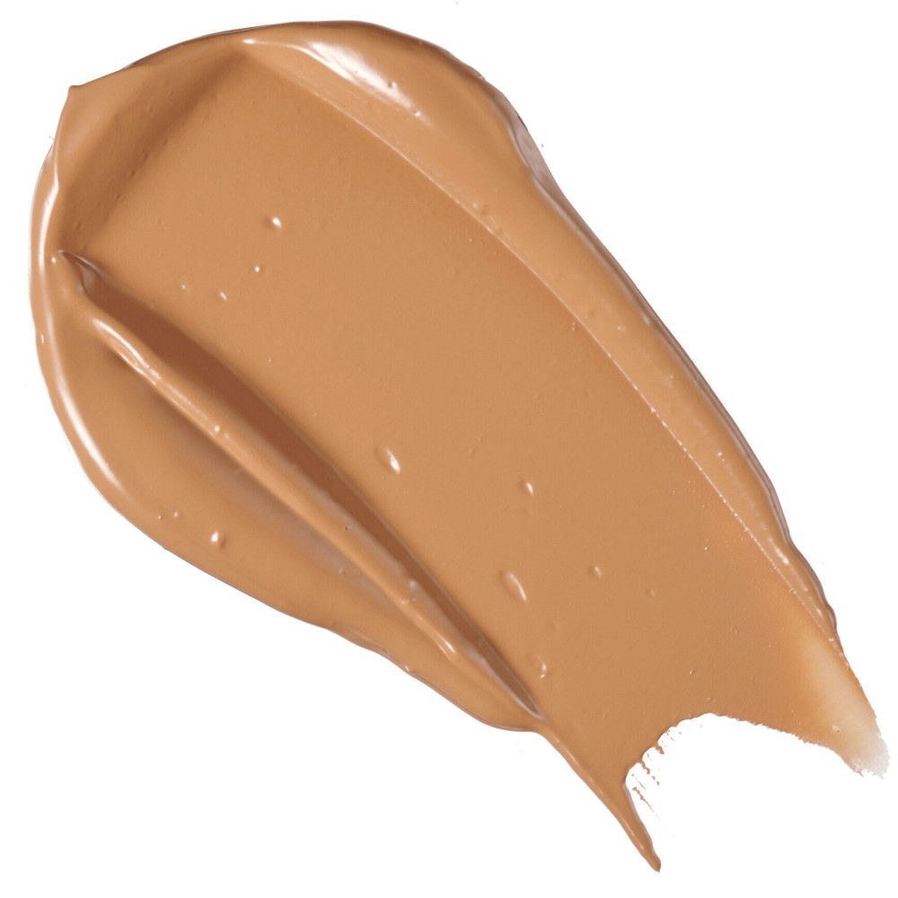 Échantillon de correcteur brun clair sur fond blanc. Texture brillante.