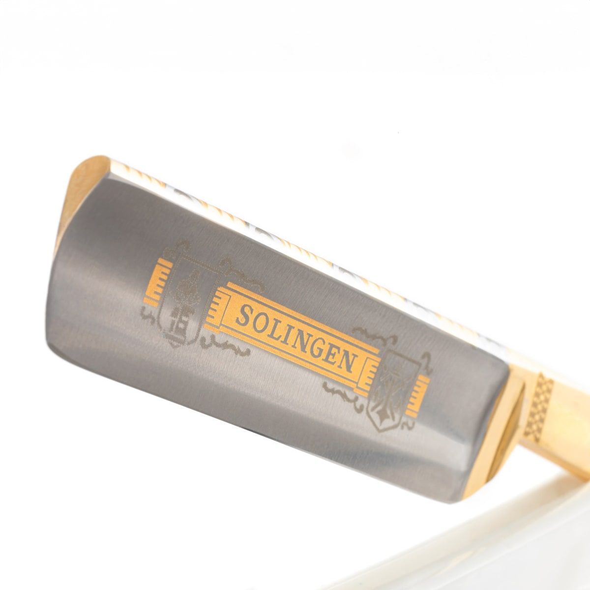 Scheermes met gouden SOLINGEN-opschrift. Metalen mes, handvat van licht materiaal.