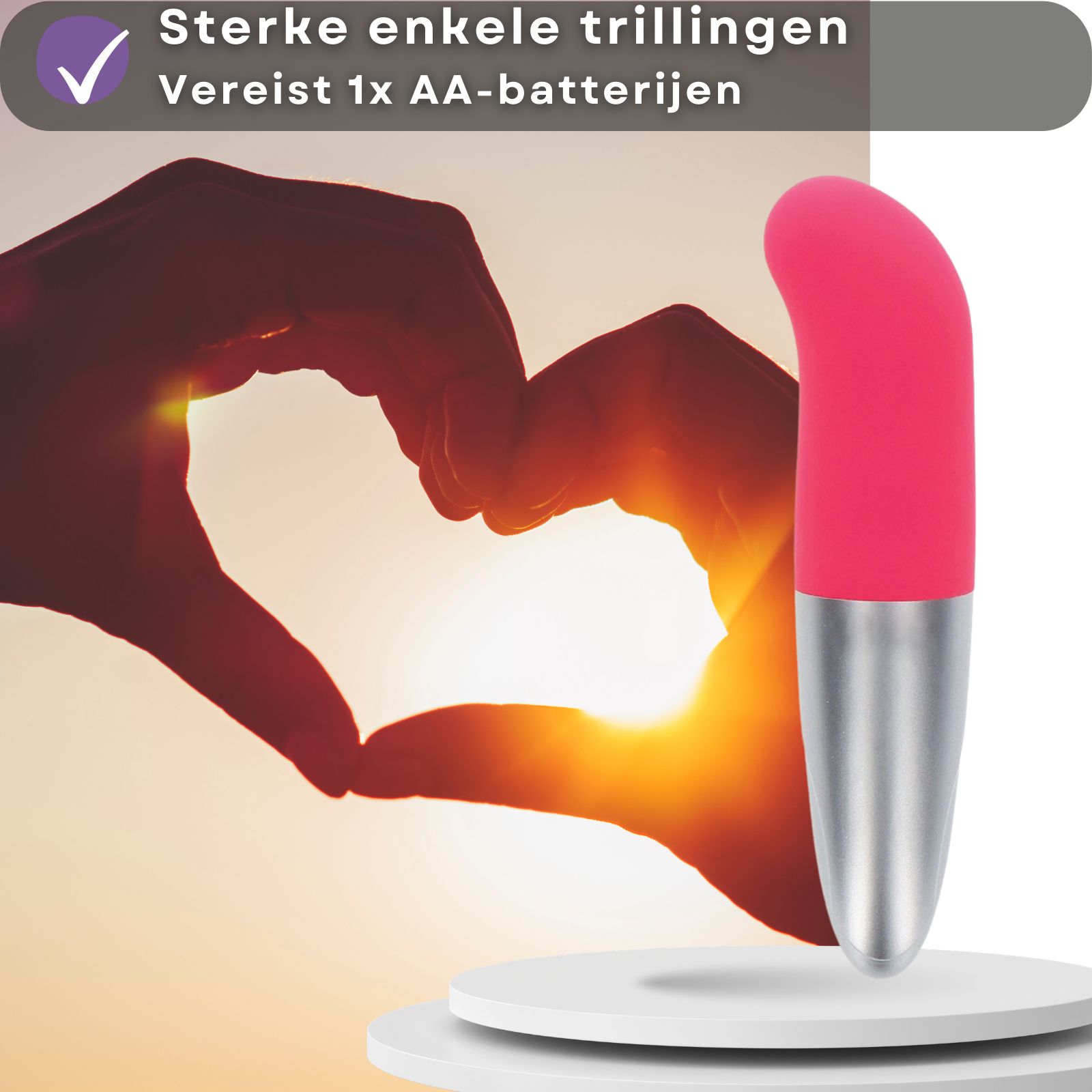 Roze en zilveren vibrator. Hartvorm met handen op de achtergrond.