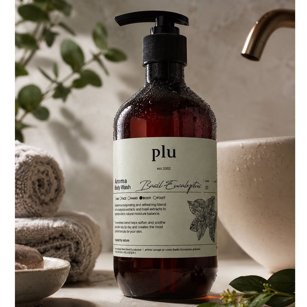 PLU Aroma Douchegel Basilicum & Eucalyptus naast handdoeken en een kom.
