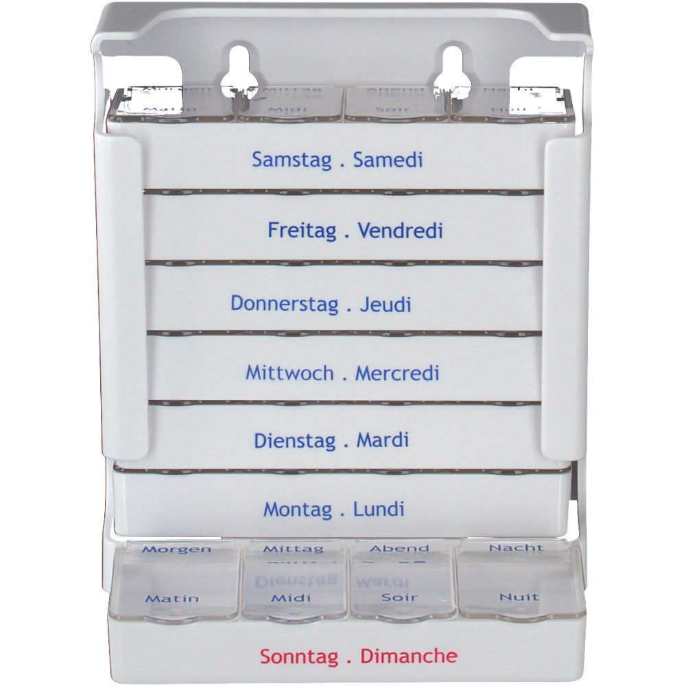 Distributeur de médicaments blanc. Sept compartiments pour les jours de la semaine, quatre pour les moments de la journée. Inscriptions en allemand et français.