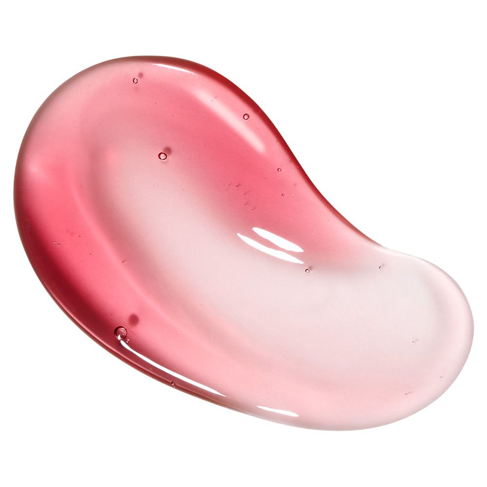 Een roze-rode serumtextuur met luchtbelletjes, verspreid op een glad oppervlak.